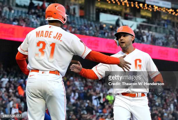 LaMonte Wade Jr. #31 and Michael Conforto of the San Francisco Giants celebrate after scoring against the Los Angeles Dodgers in the bottom of the...
