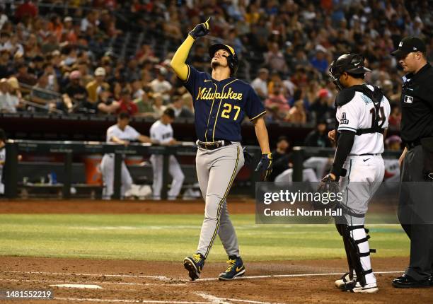 Willy Adames of the Milwaukee Brewers gestures to the sky while crossing home plate after hitting a solo home run against the Arizona Diamondbacks...