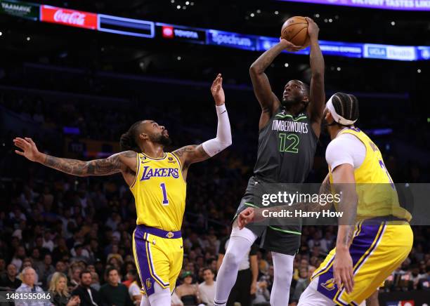 Taurean Prince of the Minnesota Timberwolves attempts a shot betweem D'Angelo Russell and Anthony Davis of the Los Angeles Lakers during the first...