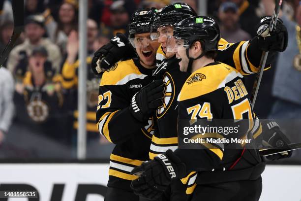 Tomas Nosek of the Boston Bruins, center, celebrates with Hampus Lindholm and Jake DeBrusk after scoring a goal against the Washington Capitals...