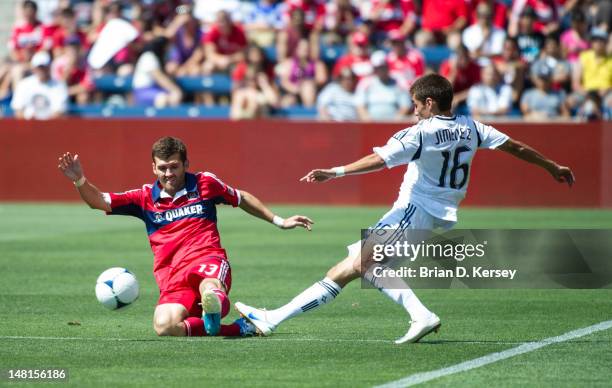 Hector Jimenez of the Los Angeles Galaxy kicks the ball as Gonzalo Segares of the Chicago Fire defends on July 8, 2012 at Toyota Park in Bridgeview,...