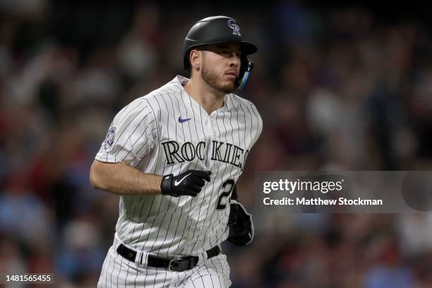 Cron of the Colorado Rockies circles the bases after hitting a solo home run against the St Louis Cardinals in the fifth inning at Coors Field on...