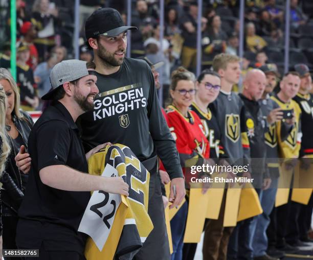 Vegas Golden Knights photographer Zak Krill poses with Michael Amadio of the Golden Knights after Amadio gave Krill his jersey during the team's...