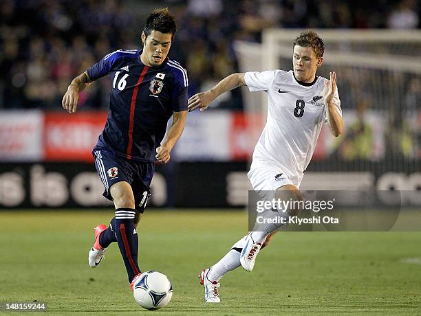 Hotaru Yamaguchi of Japan controls the ball against Michael McGlinchey of New Zealand during the international friendly match between Japan U-23 and...