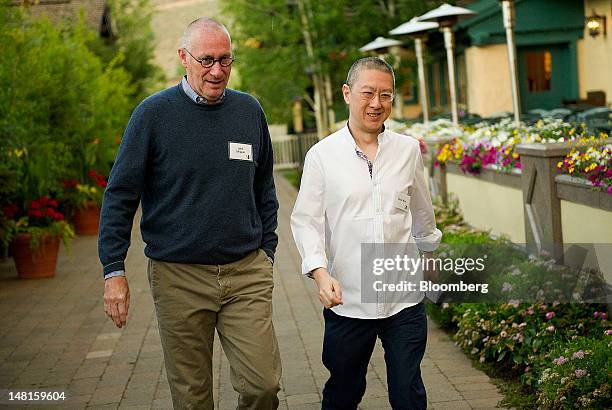 John Skipper, president of ESPN Inc. And co-chairman of Disney Media Networks, left, and Victor Koo, chief executive officer of Youku Inc., arrive...