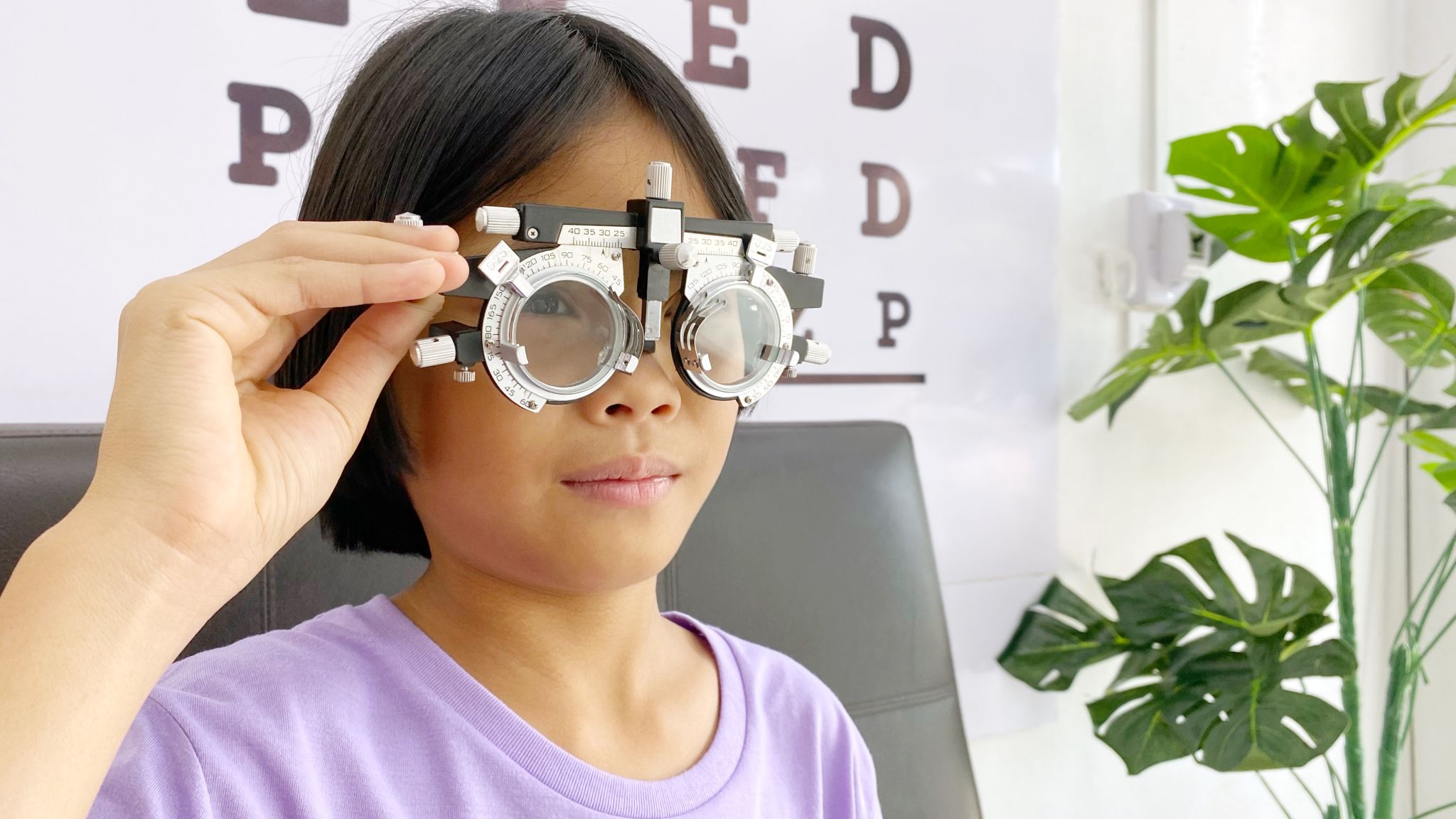 Eye test, Child wearing eyeglasses for medical eye test in clinic , eye exam, eye test concept, kid eye test Eye test, Child wearing eyeglasses for medical eye test in clinic , eye exam, eye test concept, kid eye test