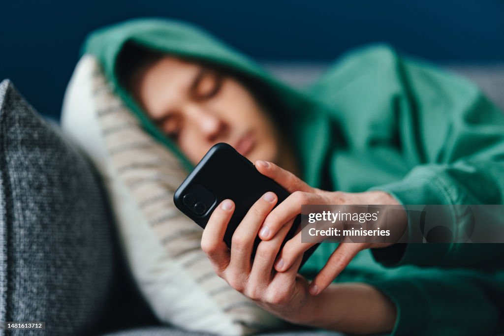 Close Up Photo Of Teenager Hands Using A Mobile Phone At Home