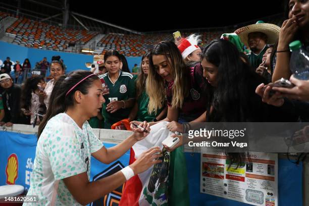 María Sánchez of Mexico signs a Mexico flag after the match between the Mexican Women's National Team and Houston Dash at Shell Energy Stadium on...