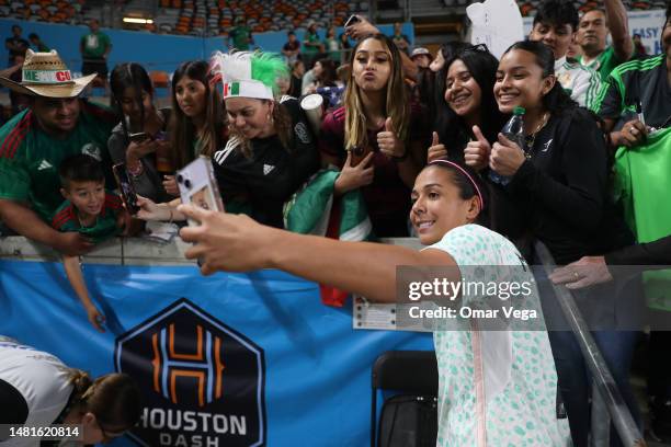 María Sánchez of Mexico takes a selfie with fans during a friendly match between the Mexican Women's National Team and the Houston Dash at Shell...