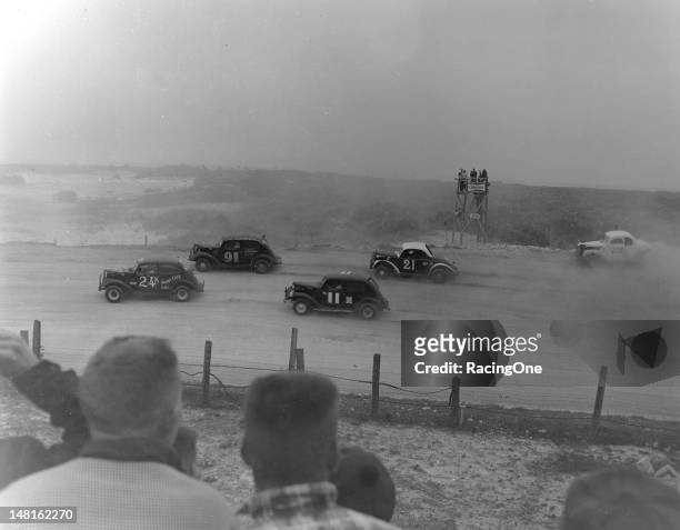February 25, 1955: Action during the NASCAR Sportsman race on the Daytona Beach-Road Course has James Stultz leading Earl Moss , Wendell Scott , Ray...