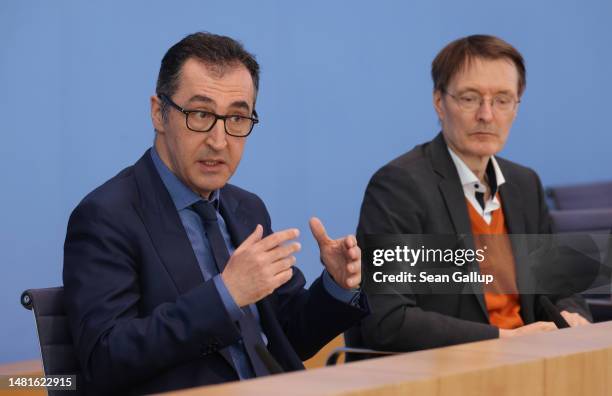 German Health Minister Karl Lauterbach and Agriculture Minister Cem Oezdemir speak to the media to present the governing coalition's new cannabis...