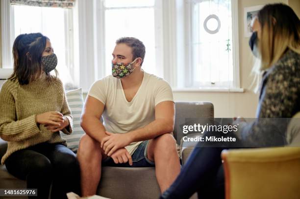 therapy, psychology counseling and couple with mask for session, consulting and relationship advice. covid, marriage help and therapist with clients in conversation, discussion and communication - clinic room stock pictures, royalty-free photos & images