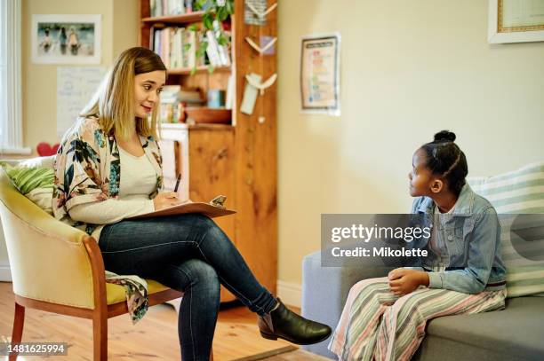 psychologist, black girl and consultation in office for support, help or mental health. psychology doctor, therapist and kid consulting woman in counselling, therapy or talking for advice on sofa. - clinic room stock pictures, royalty-free photos & images