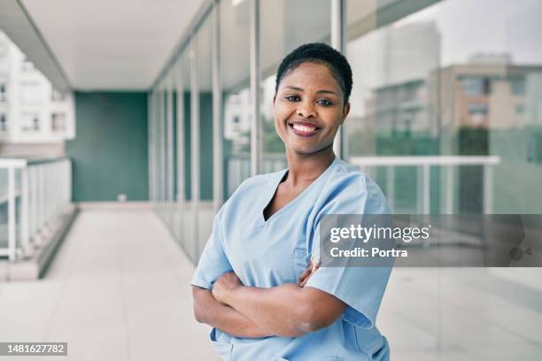 portrait of a cheerful young african woman nurse working in hospital - female nurse stock pictures, royalty-free photos & images