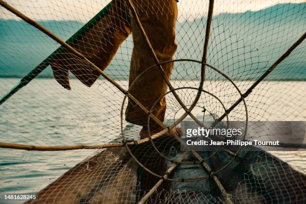 on a boat - intha fisherman of inle lake, myanmar - heritage round one imagens e fotografias de stock