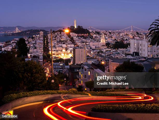 light trails of lombard street - lombard street san francisco stock-fotos und bilder