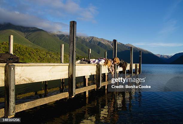 children playing at lake - nelson lakes national park stock pictures, royalty-free photos & images