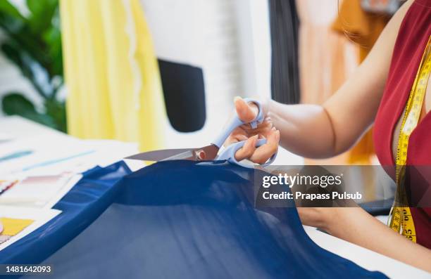 woman measuring fabric in fashion design studio - needlecraft ストックフォトと画像