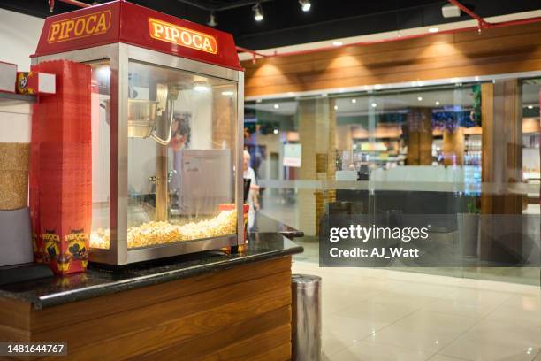 popcorn maker on concession stand in a movie theater - snackbar stock pictures, royalty-free photos & images