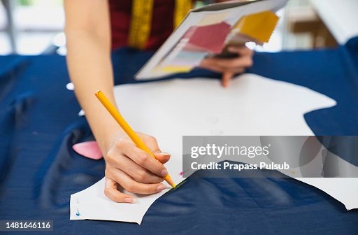 Woman measuring fabric in fashion design studio Woman measuring fabric in fashion design studio