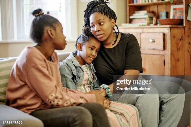 love, comfort and children with mother on a sofa holding hands, hug and sharing compassion in their home. family, support and mom with unhappy kids in living room for help, understanding and empathy - children divorce stock pictures, royalty-free photos & images