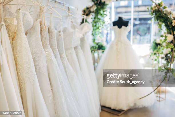 bridal dresses in the bridal shop - wedding dress stockfoto's en -beelden