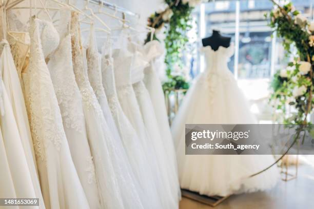 bridal dresses in the bridal shop - white wedding dress stock pictures, royalty-free photos & images