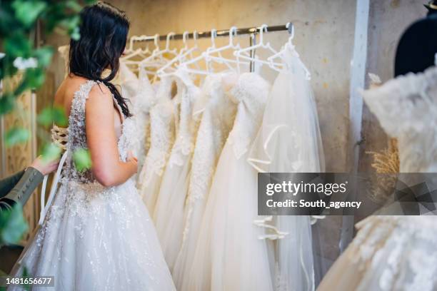 bride trying out wedding dressing the bridal shop - bride dress stock pictures, royalty-free photos & images