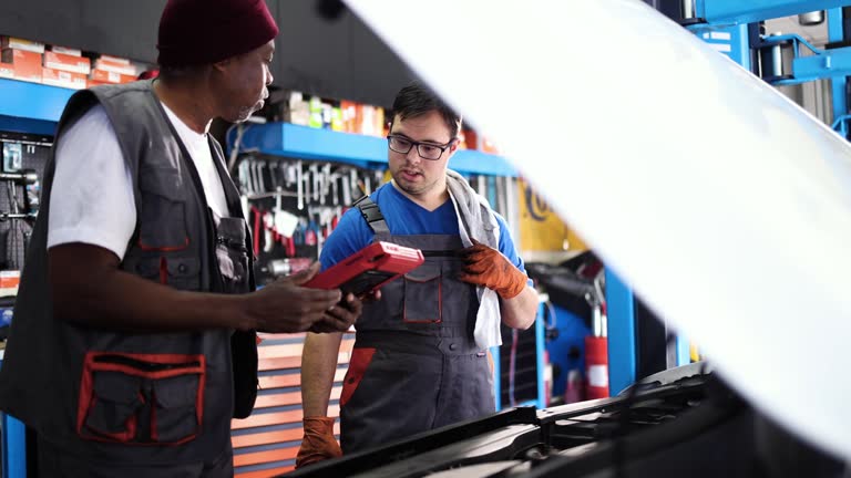https://media.gettyimages.com/id/1481659410/video/senior-mechanic-and-his-trainee-with-down-syndrome-talking-about-the-car-engine.jpg?b=1&s=640x640&k=20&c=oLzUVEzTNXvco6Gd_T6JToct9KfB1MeBfy8XZicZnBg=