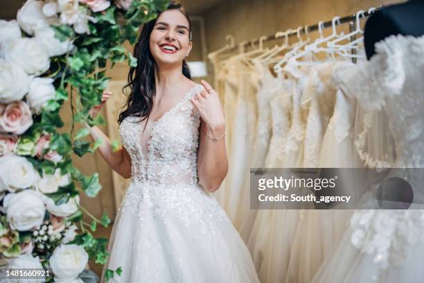 bride trying out wedding dressing the bridal shop - bridal shop stock pictures, royalty-free photos & images