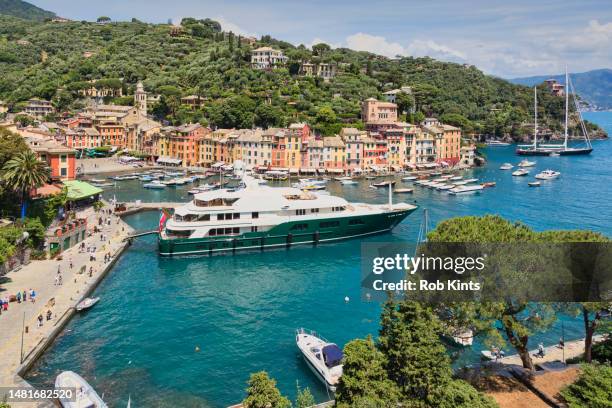 luxury yachts and boats in  portofino harbor on the italian riviera near genoa  and cinque terre - portofino stock-fotos und bilder