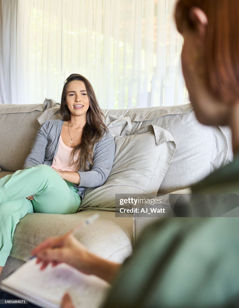 Young woman smiling while talking with her therapist during a counseling session