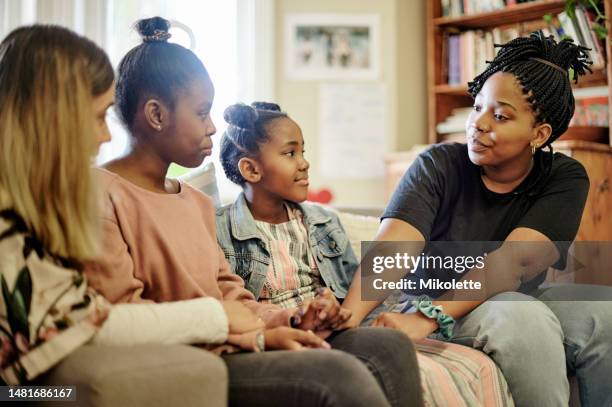 children, counseling and education center for kids talking to a counselor or therapist before adoption in a house or home. group and woman in discussion with young people for mental health support - mental health awareness stock pictures, royalty-free photos & images