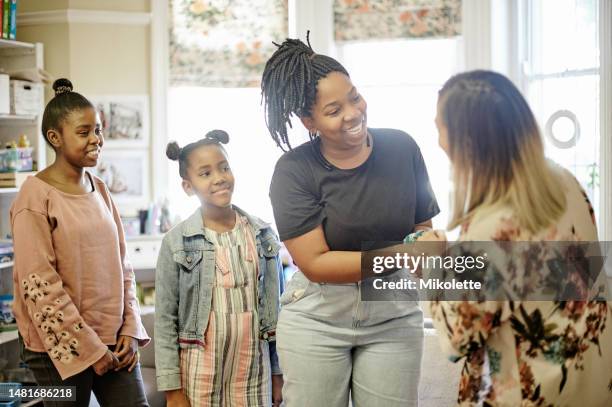 parent, teacher and kids meeting in classroom at montessori school for education, learning and teaching. child development, mother and educator handshake, conversation and young students in class. - förälder bildbanksfoton och bilder