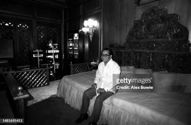Philippine government investigator and lawyer Jovito Salonga sits on the bed of former First Lady Imelda Marcos in her suite at the Malacanang...