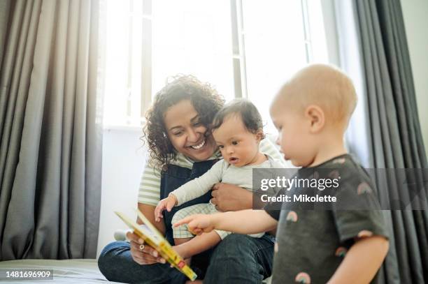 mother, babies and learning with book in home, storytelling and education in house. development, care and happy mama or babysitter reading with children, kids or toddlers while bonding and having fun - three storey stock pictures, royalty-free photos & images