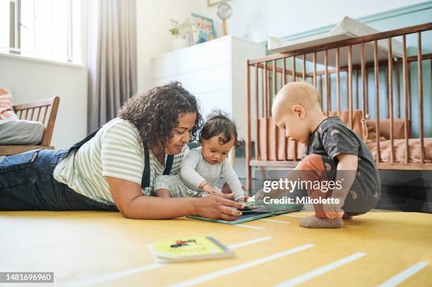 babysitter, babies and reading book for learning in home, storytelling or education in house. development, care or nanny read fantasy with children, kids or toddlers while bonding together in nursery - three storey stock pictures, royalty-free photos & images