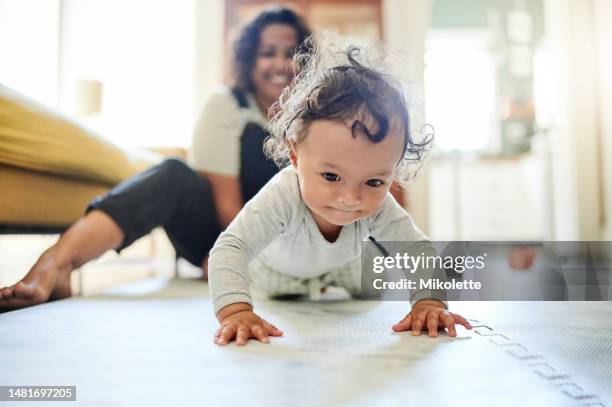 mother, family and baby crawling on floor in living room learning to walk, child development and motherhood. love, home and happy mom and kid for bonding, quality time and relax together on floor - baby crawling stock pictures, royalty-free photos & images