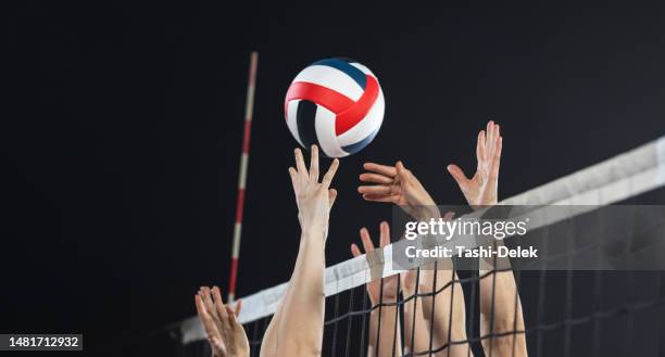 female volleyball players in action - girls volleyball stock pictures, royalty-free photos & images