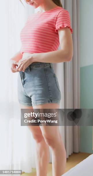 woman cannot get into jeans - liposuction stock pictures, royalty-free photos & images