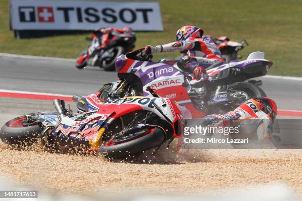 Marc Marquez of Spain and Repsol Honda Team crashed out with Miguel Oliveira of Portugal and Cryptodata RNF MotoGP Team during the MotoGP race during...