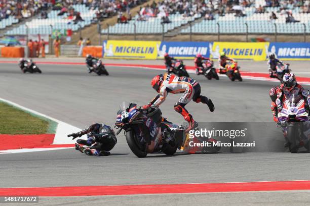Marc Marquez of Spain and Repsol Honda Team crashed out with Miguel Oliveira of Portugal and Cryptodata RNF MotoGP Team during the MotoGP race during...