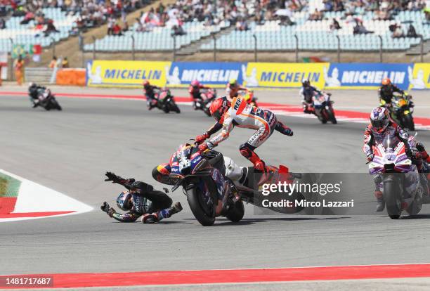 Marc Marquez of Spain and Repsol Honda Team crashed out with Miguel Oliveira of Portugal and Cryptodata RNF MotoGP Team during the MotoGP race during...