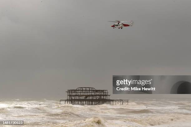 Coastguard helicopter scours the rough sea off the Brighton coast on April 12, 2023 in Brighton, United Kingdom. Storm Noa, named by the french...