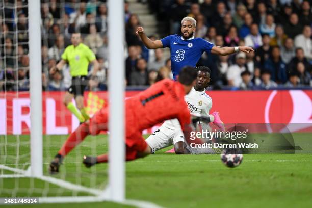 Reece James of Chelsea shoots whilst under pressure from Eduardo Camavinga as Thibaut Courtois of Real Madrid makes a save during the UEFA Champions...