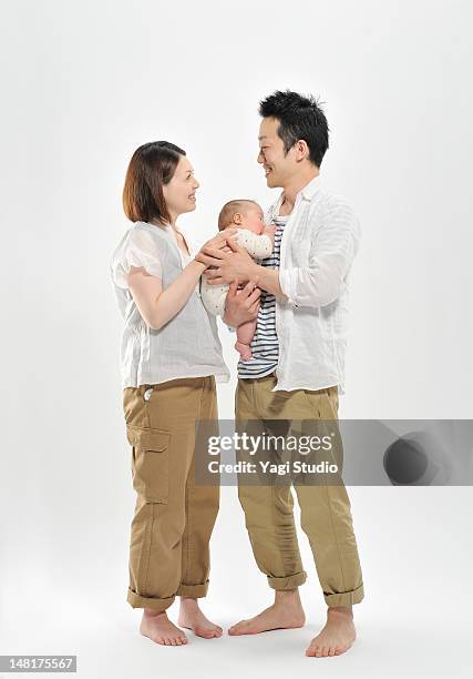 portrait of mom, dad and baby girl - family white background stock pictures, royalty-free photos & images