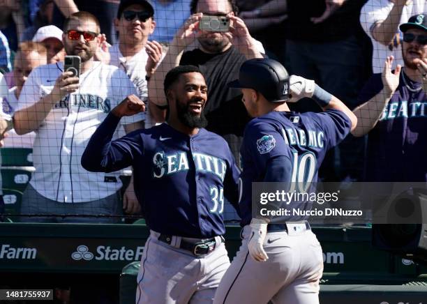 Jarred Kelenic of the Seattle Mariners is congratulated by Teoscar Hernandez of the Seattle Mariners following a home run during the eighth inning...