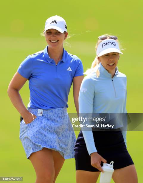 Linnea Strom of Sweden and Pernilla Lindberg of Sweden joke as they approach the green on then12th hole during the first round of the LOTTE...