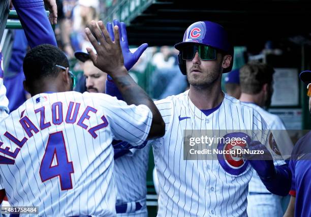 Cody Bellinger of the Chicago Cubs is congratulated by Nelson Velazquez of the Chicago Cubs following a home run during the ninth inning against the...