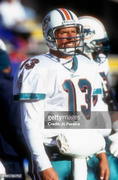 Quarterback Dan Marino of the Miami Dolphins follows the action in the NFL Wildcard Playoff Game between the Miami Dolphins vs the New England...